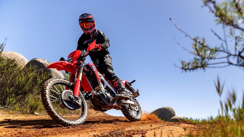 A Honda CRF450RL racing down a dirt path.