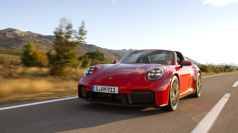 Woman driving a red Porsche