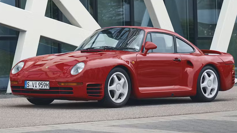 Red Porsche 959 front parked in front of a building