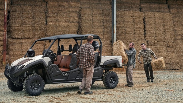 Workers load hay into Yamaha Viking VI Ranch Edition