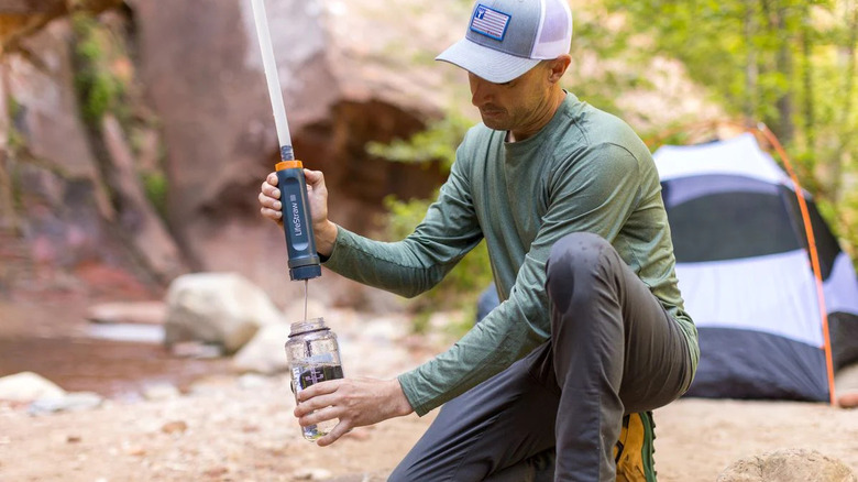 man using LifeStraw Gravity Filter to refill bottle