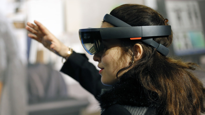 A woman uses a Microsoft HoloLens