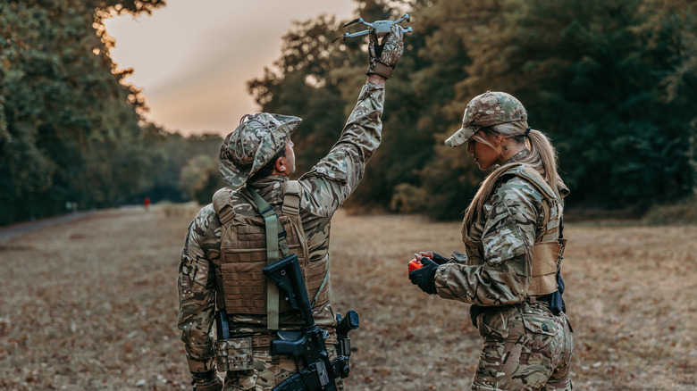 Two soldiers prepare to release a drone