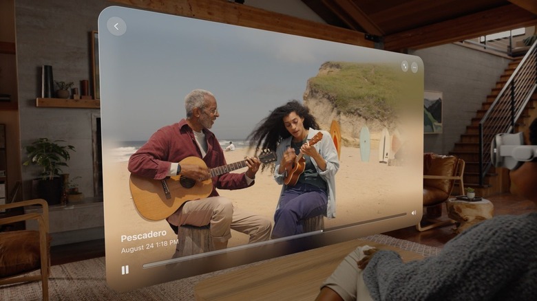 woman watching video of people playing guitar on the beach using the Apple Vision Pro