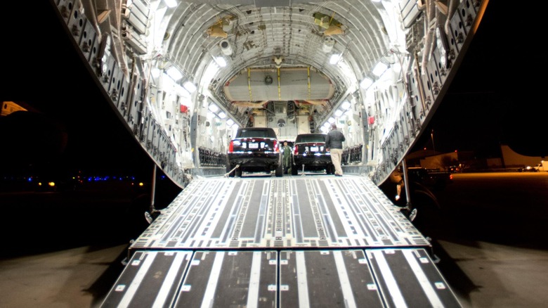 Presidential limos loaded in the cargo hold of a USAF transport aircraft