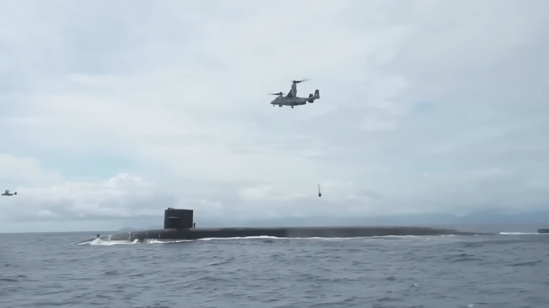 V-22 Osprey heliciopter dropping supplies to a U.S. Navy submarine.