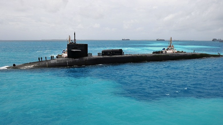 The Ohio-class guided-missile submarine USS Georgia (SSGN 729) prepares to moor outboard of the submarine tender USS Emory S. Land (AS 39) in Diego Garcia.