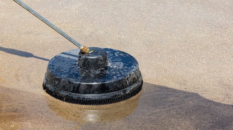 Surface cleaner washing driveway