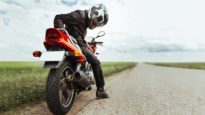 Man looking at motorcyle tire