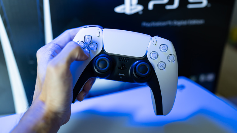 PS5 DualSense controller in hand