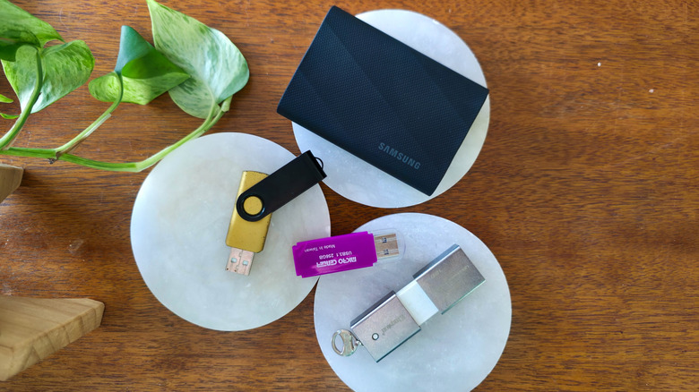 A trio of flash drives alongside a Samsung T9 portable SSD