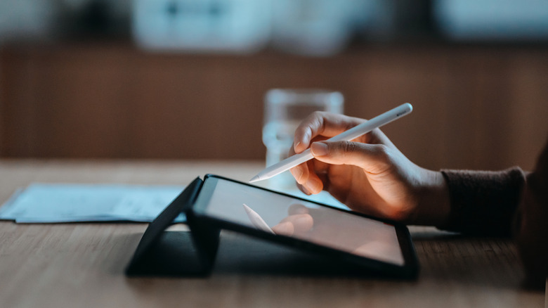 person using ipad with pencil