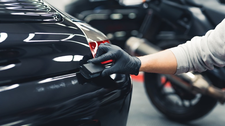 Applying ceramic coat to black car