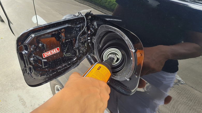 Pouring diesel additive into a tank