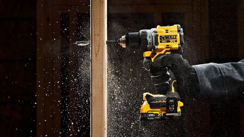 Cordless DeWalt drill drilling into a piece of wood