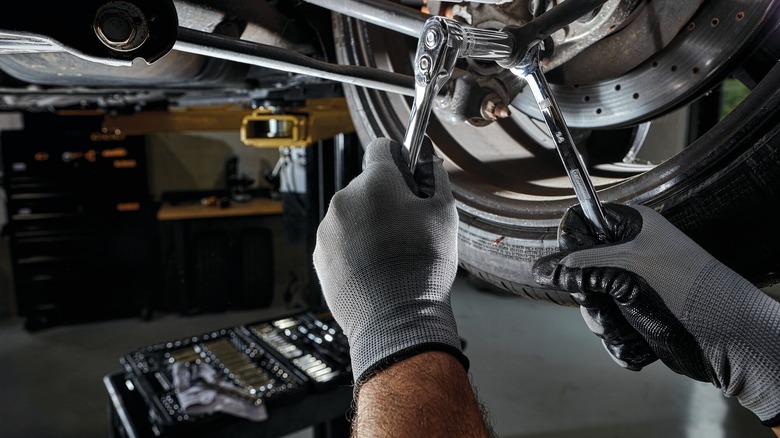 Mechanic working on a car with DeWalt tools