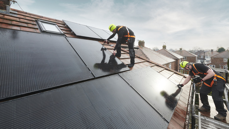 Workers installing solar panels