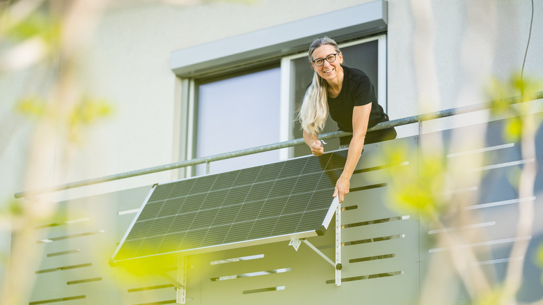 Homeowner adjusting solar panel