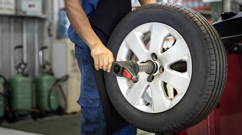 A mechanic performing a tire balancing service