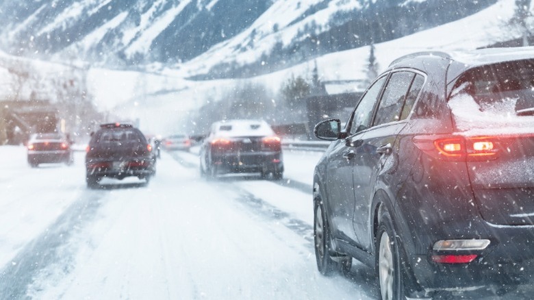 A snowy highway with several vehicles driving