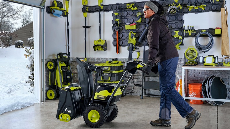 Person using Ryobi snow blower