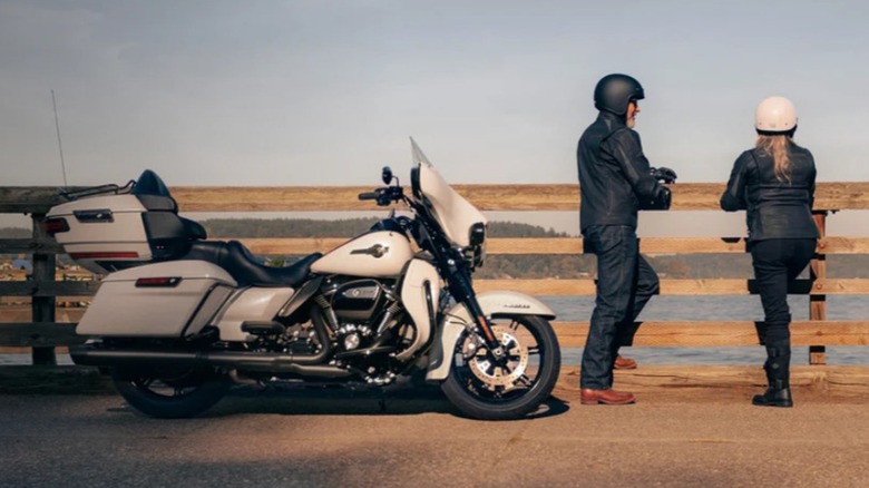 Bikers standing near a Harley-Davidson