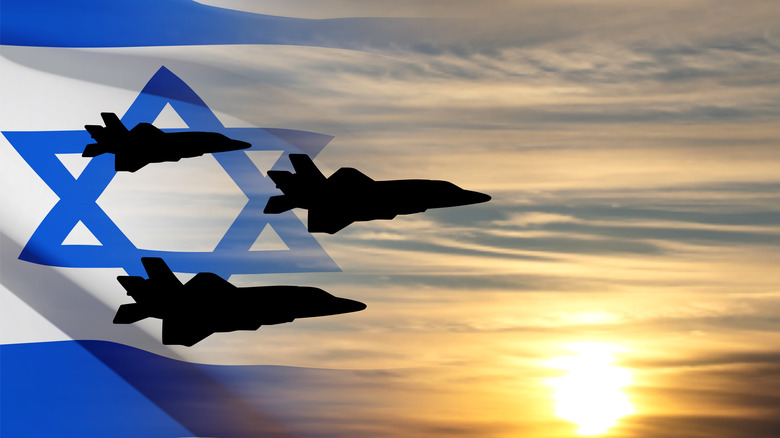 Fighter jet silhouettes over Israeli flag