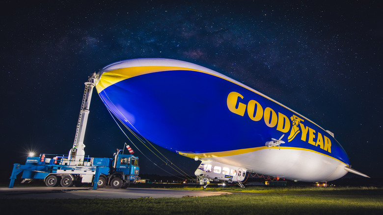 Goodyear Blimp with mooring truck at night