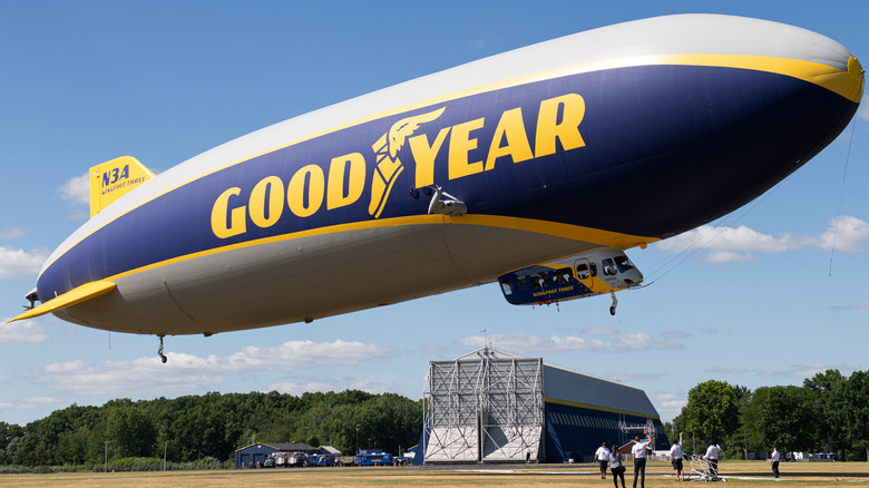 Goodyear Blimp floating over field