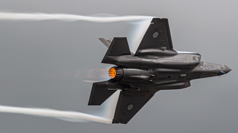 F-35 fighter jets racing through sky