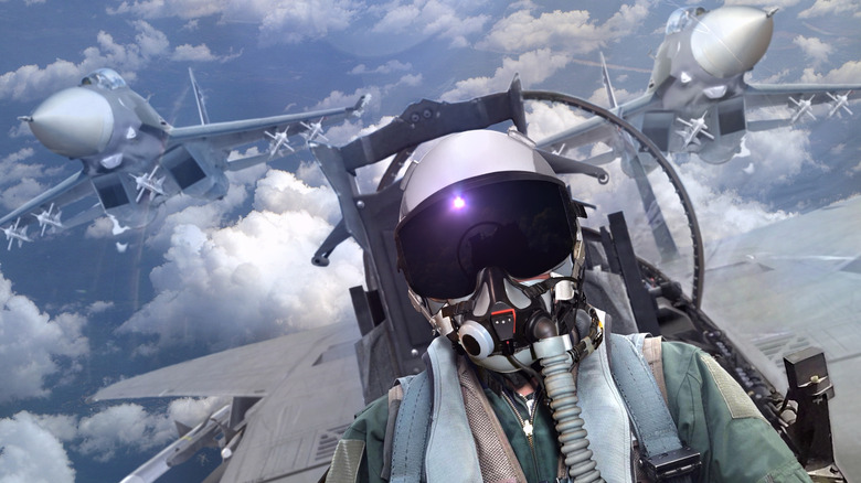 A fighter jet pilot in the sky with two other jets in the background.