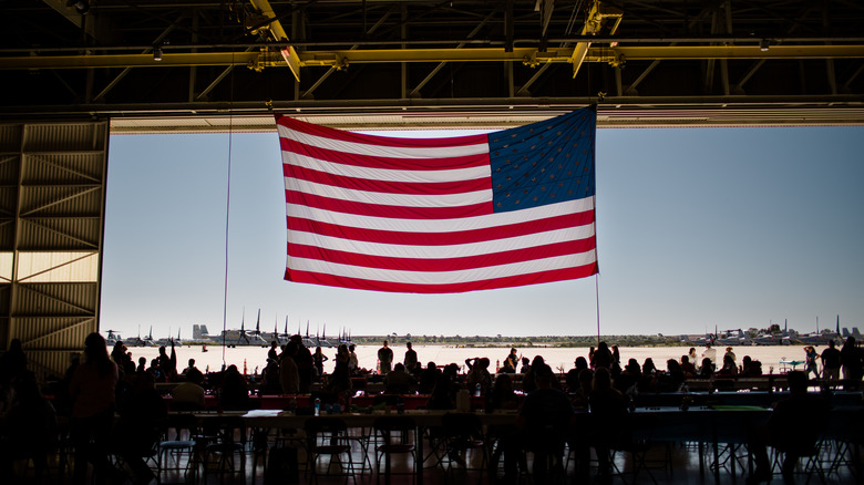 US soldiers in an hangar with American flag