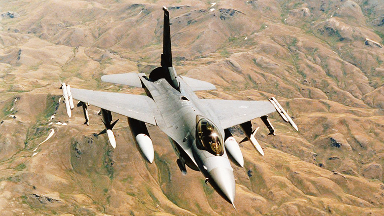 F-16 Fighting Falcon flying over mountains