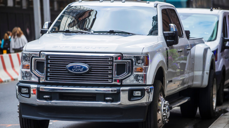 White Ford F250 Super Duty pickup in traffic on city street