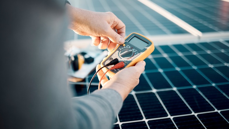 Multimeter testing roof solar panel