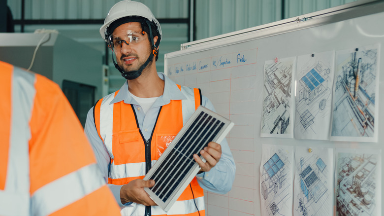 Engineer demonstrating different solar panels