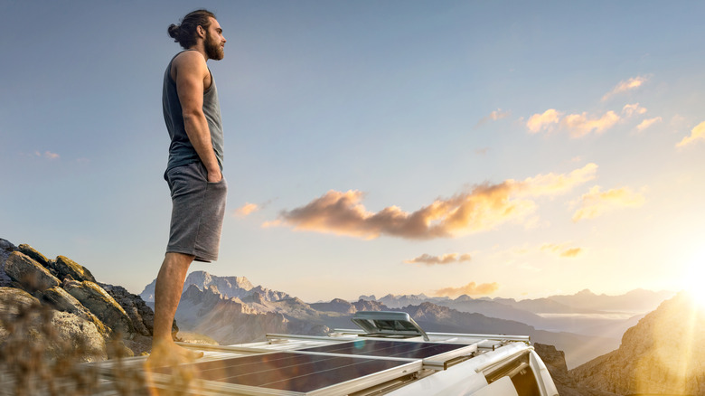 Young man watching the sun from his RV