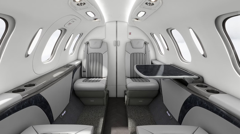 The gray and white interior of a HondaJet Elite II private aircraft.