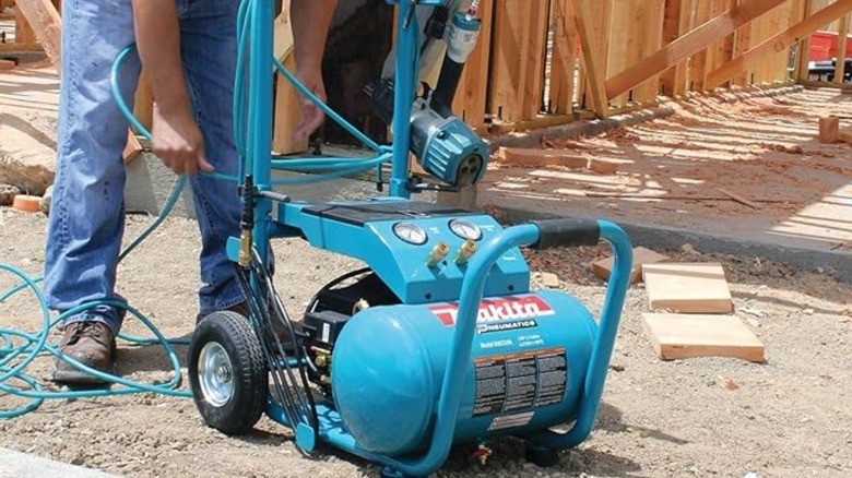 An air compressor sitting at the jobsite