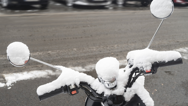 Motorcycle handlebars covered in show.