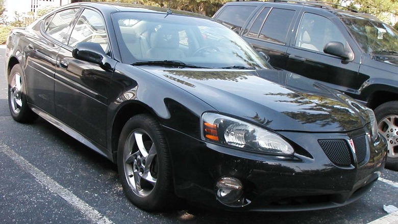 Dark colored Pontiac Grand Prix GTP in a parking lot