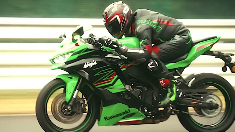 Person riding Kawasaki ZX4R