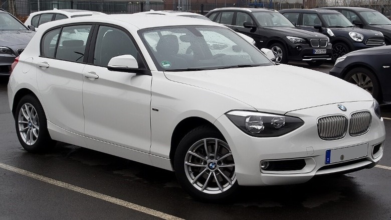 White BMW F20 1 Series parked with cars in the background