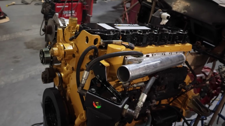 A yellow Cat engine in a garage