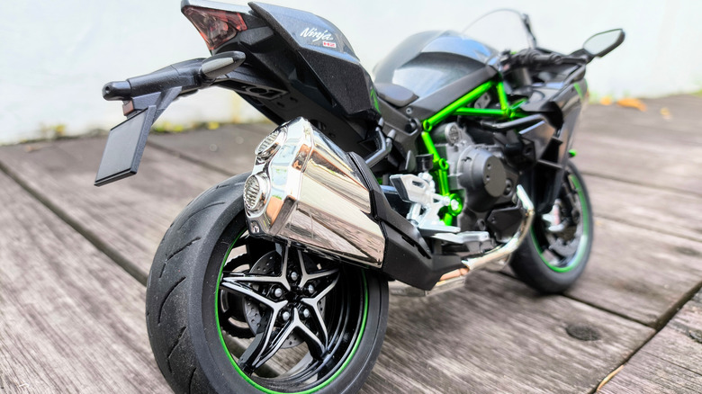 A close-up of a Kawasaki Ninja H2 model motorcycle on a wooden deck