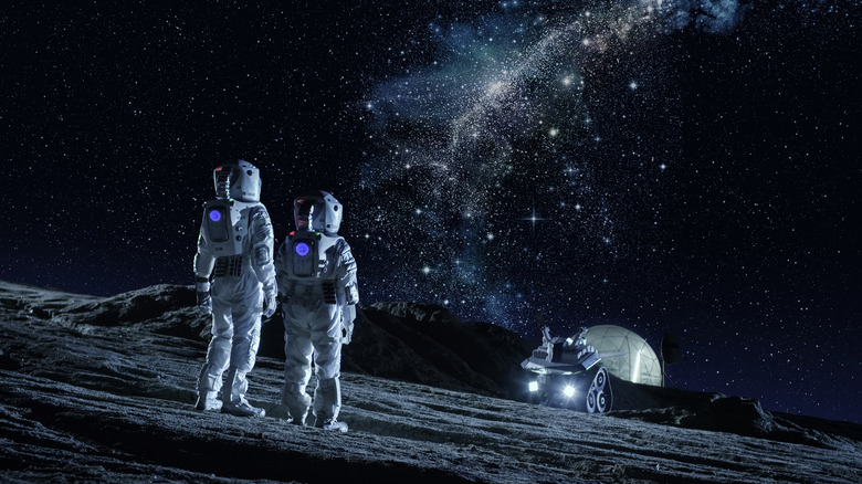 Astronauts on the moon looking at the galaxy