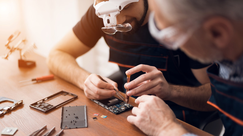 Phone repair technicians working