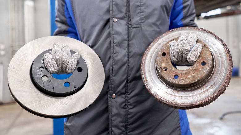 Mechanic holding two brake discs