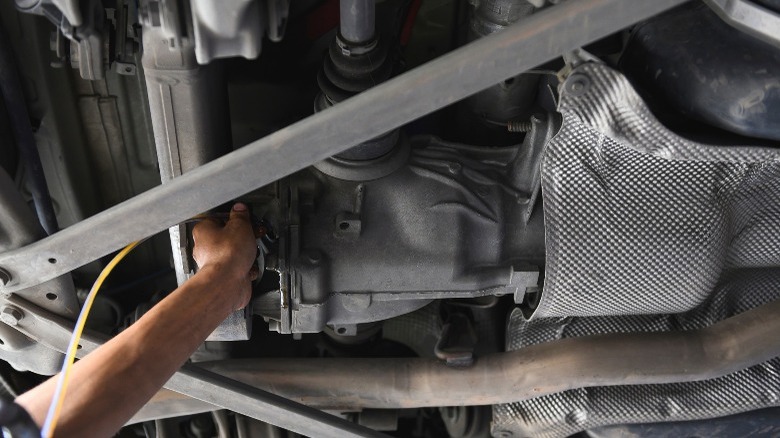 Differential fluid change on a raised car