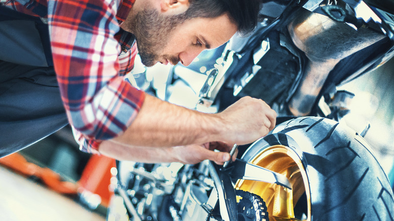 Man inspecting motorcycle